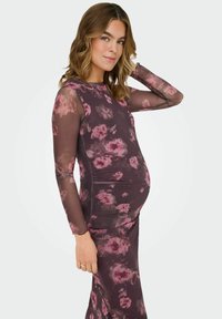 Pikkade varrukatega raseduskleit tumeda lillemustriga. Sile kangas läbipaistvate varrukatega, ümmarguse kaelusega ja keha järgiva lõikega.