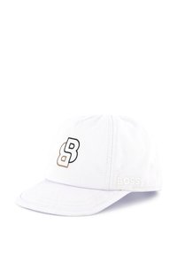 White base cap with a curved brim, featuring a black and brown logo "B" on the front, and "BOSS" embroidered on the side.