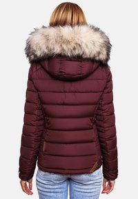 Maroon puffer jacket featuring a fur-lined hood, quilted design, and ribbed cuffs. Includes subtle branding on the side.