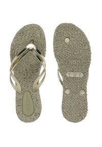Light beige sandals with textured soles, featuring metallic gold straps in a crisscross design. Brand logo is embossed on the footbed.
