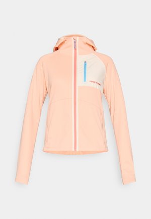 Light pink zip-up jacket with hood, cream chest panel, blue vertical zip pocket, and red logo on chest, displayed on white background.