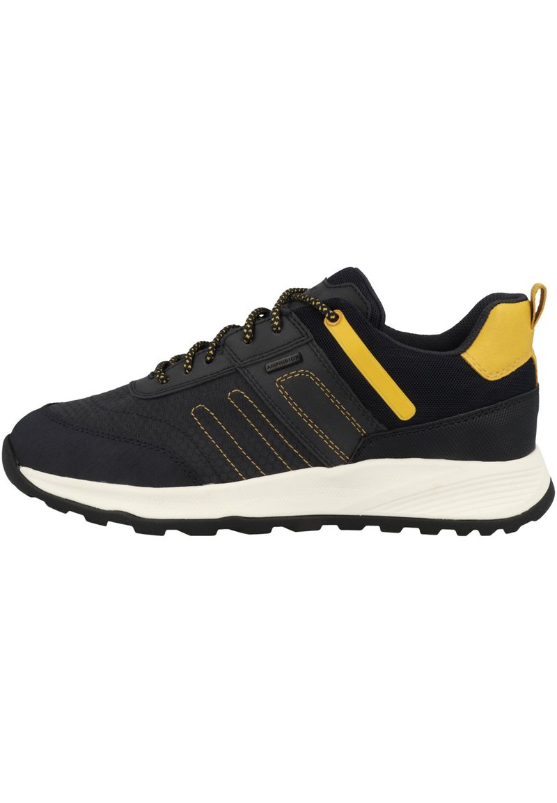 Zapatos deportivos negros con acentos amarillos, paneles texturizados y cordones negros. Presentan una entresuela blanca acolchada y una suela de goma para mayor tracción.