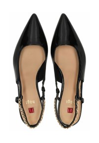 Scarpe slingback nere in vernice con punta a punta e aperture laterali. Presentano un accentuazione in catena dorata e un dettaglio quadrato rosso sul tacco.