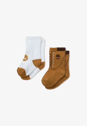 Zestaw dwóch par skarpetek: jedna biała z brązowym mankietem i logo, druga brązowa z wzorem butów i logo. Gładki dzianiny, wysokość kostki.