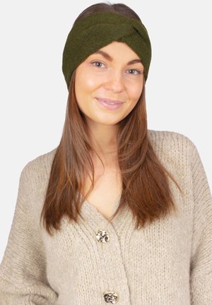 Green knit headband with twisted design, soft texture. Accompanied by a beige chunky cardigan featuring gold-tone buttons.