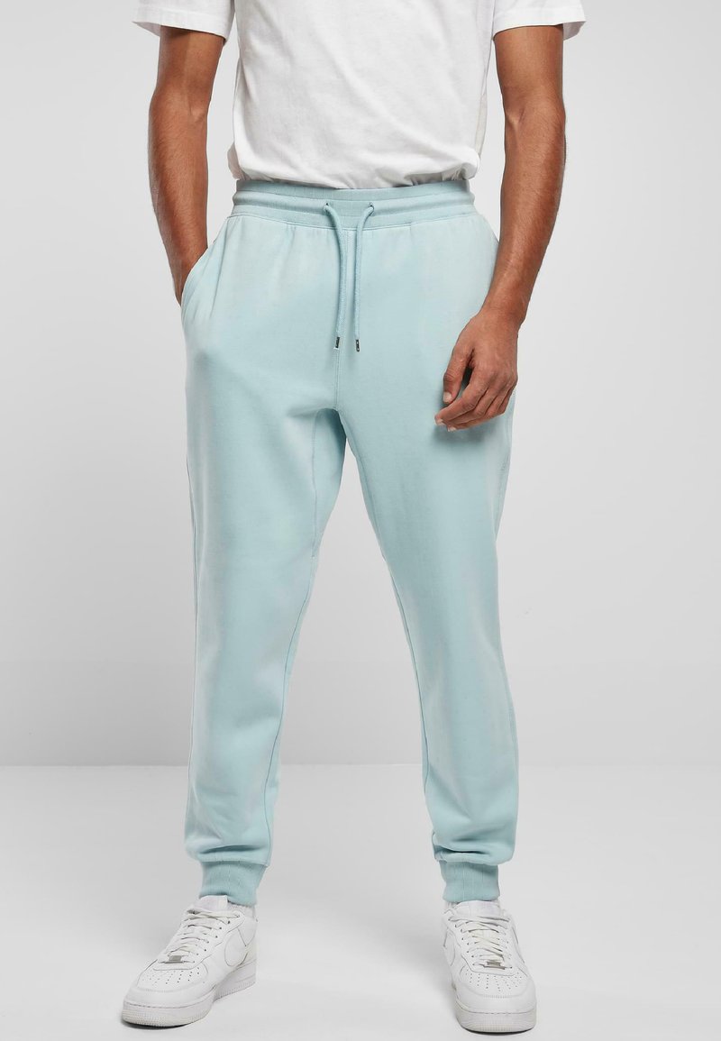 Lys blå slim-fit joggebukser laget av myk stoff, med elastisk midje med snor, sidelommer og ribbede mansjetter.