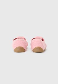 Pink fuzzy slippers with a soft texture, featuring a back strap and lightweight rubber sole, showcasing a simple, rounded design.