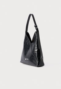 Maza melna ādas plecu soma ar vienu regulējamu siksnu un smalku sudraba logotipu priekšpusē.