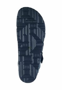 Dark blue rubber shoe sole featuring a textured, patterned surface with raised geometric shapes and logos for grip and durability.