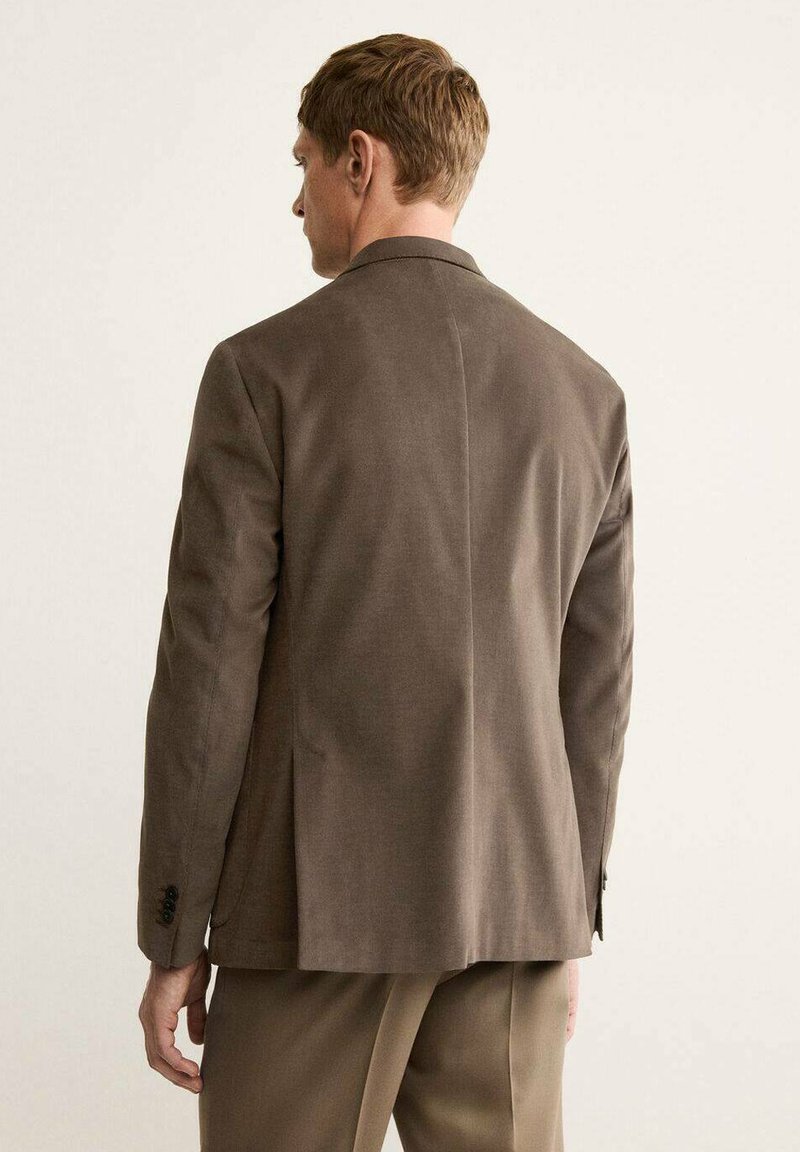Brown blazer featuring a classic design, tailored fit, and textured fabric. Back view shows a single vent and buttoned cuffs.