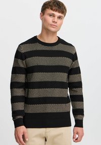 Black and gold striped sweater with a textured knit design, round neckline, and ribbed cuffs and hem.