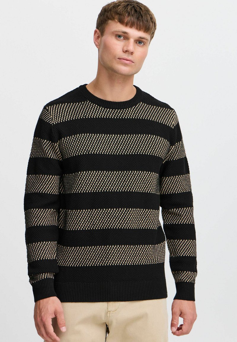 Black and gold striped sweater with a textured knit design, round neckline, and ribbed cuffs and hem.