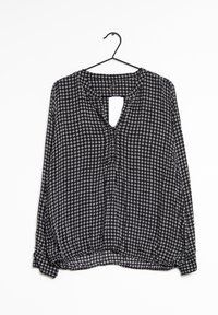 Blouse à carreaux noir et blanc avec col en V, manches longues, ourlet froncé et détail dos ouvert. Fabriquée en tissu léger.