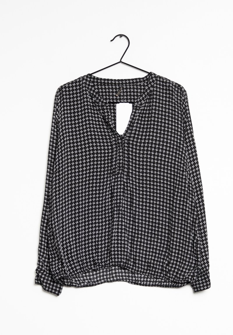 Blouse à carreaux noir et blanc avec col en V, manches longues, ourlet froncé et détail dos ouvert. Fabriquée en tissu léger.