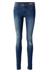 Úzké džíny vyrobené z modrého denimového materiálu, s distressed designem, záměrně bledými místy a trhlinami, v pětiskládovém stylu a na zip.