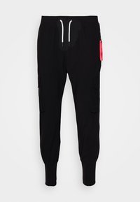 Černé cargo kalhoty s elastickými manžetami, šňůrkou v pase, bočními kapsami a akcentem v podobě růžové visačky. Vyrobeny z jemné, lehké tkaniny.