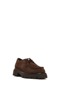 Brown suede lace-up shoe with thick ridged dark sole and rounded toe, angled slightly to right on white background.