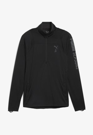 Zwarte pullover met lange mouwen en een kwart rits, textuurstof, zijzakken en een reflecterende "PUMA SEASONS" logo op de mouw.