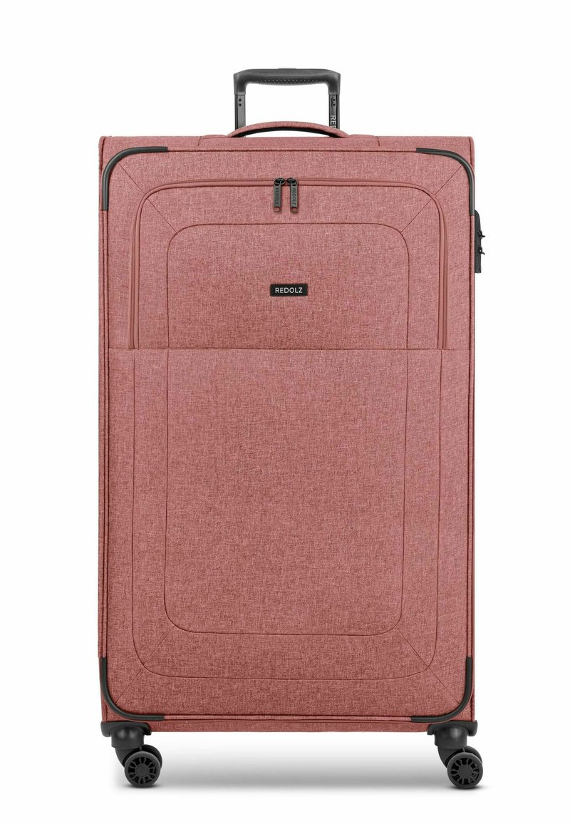 Valigia spinner in tessuto rosso chiaro con superficie testurizzata, dotata di tasca frontale, manico reclinabile e quattro ruote.