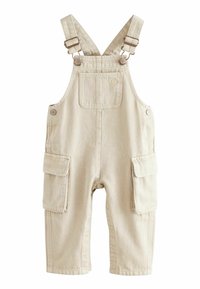 Salopette en coton beige avec bretelles ajustables, deux poches avant et deux poches cargos latérales. Conçue avec un tissu texturé et durable.