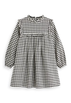 Vestido a cuadros en blanco y negro con mangas largas, escote rizado y cintura fruncida. Confeccionado en un tejido ligero con una textura suave.