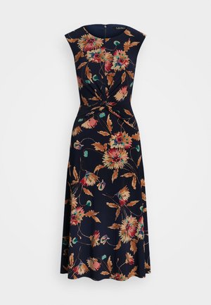 Ærmeløs navy-kjole med en snoet knude i taljen og et blomsterprint i beige, rød, grøn og turkis farver.