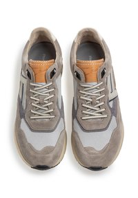 Light gray and beige sneakers with suede and mesh panels, round toe, and lace-up design. Features a tan tag and textured sole.