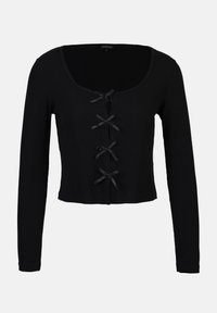 Černý žebrovaný crop top, má dlouhé rukávy a zaoblený výstřih. Přední zapínání se zdobnými černými stužkami. Texturovaná tkanina.