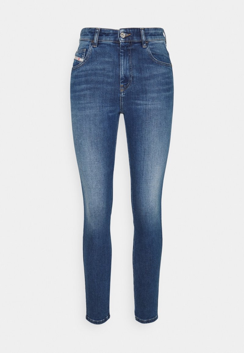 Jeans skinny de tiro alto en azul con detalles deslavados, diseño estándar de cinco bolsillos, cierre de botón y trabillas para cinturón.