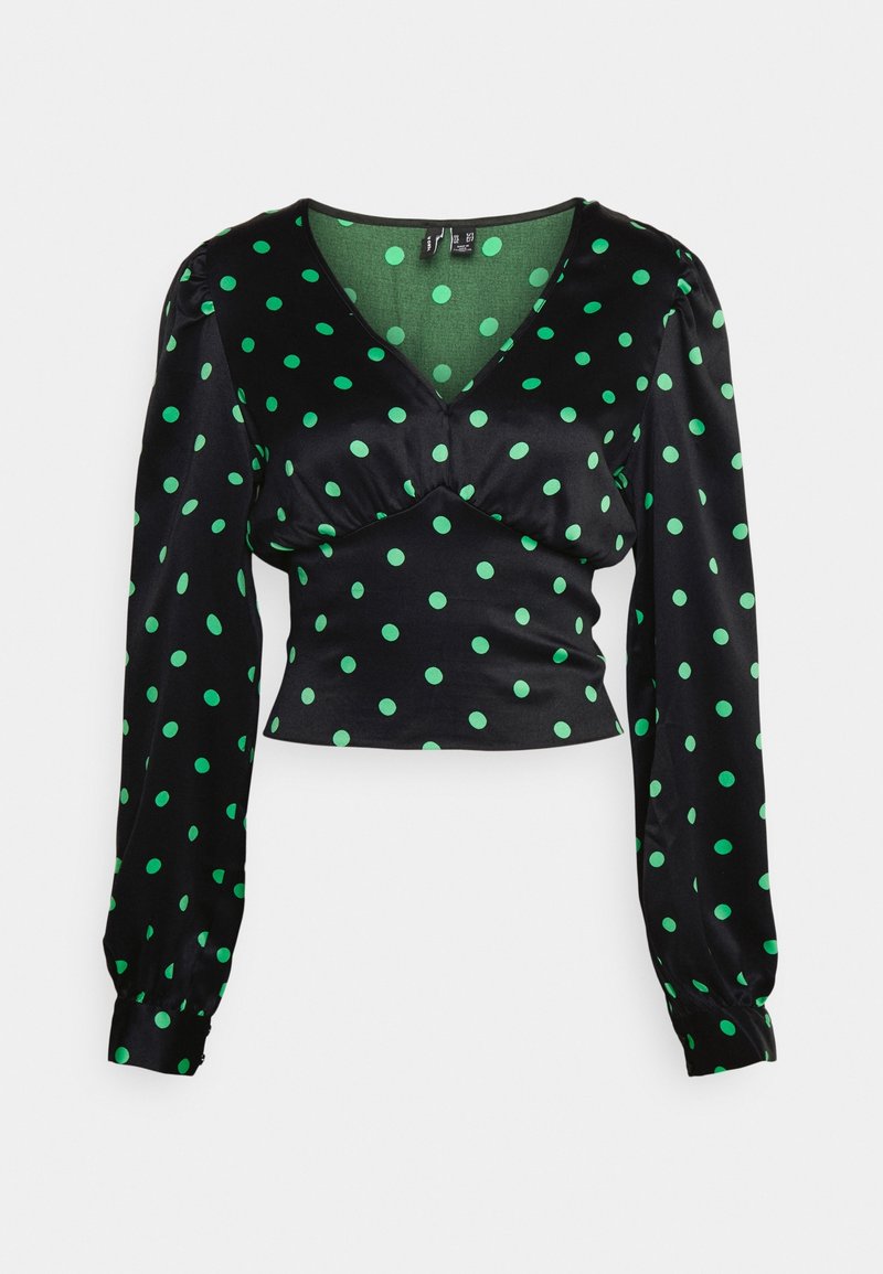 Blouse noire en satin à manches longues avec des pois verts, col en V, taille cintrée et épaules légèrement bouffantes.