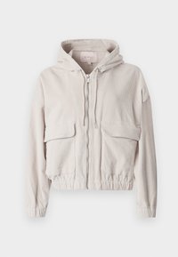 Ljus beige kordjacka, kort modell, med huva, dragkedja fram, dragskor, elastisk midja och två stora fickor med lock fram.