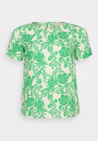 Kortärmad topp i ljus krämfärgad tyg med ett livligt grönt blommigt och bladigt mönster, som har en rund halsringning och avslappnad passform.