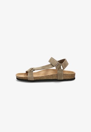Sandalia beige de punta abierta con tiras ajustables, plantilla de corcho y suela negra texturizada mostrada de perfil.