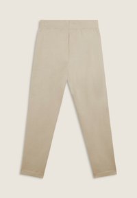 Leggings beige con cintura elástica, textura suave y diseño de pierna ajustada. Sin costuras visibles ni patrones. Estilo simple y minimalista.