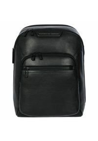 Zaino in pelle nera con una forma strutturata, due scomparti con zip e un dettaglio con logo nella parte superiore. Texture liscia e design minimalista.