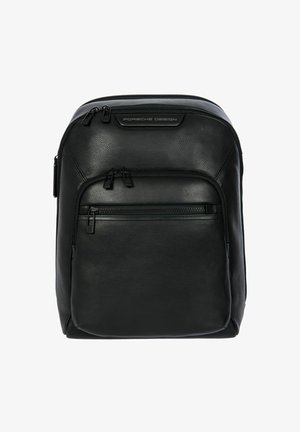 Zaino in pelle nera con una forma strutturata, due scomparti con zip e un dettaglio con logo nella parte superiore. Texture liscia e design minimalista.