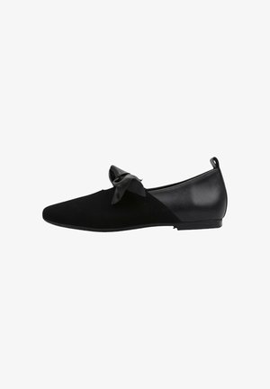 Ballerines noires en daim souple et en cuir synthétique, avec un nœud prominent d'un côté et une semelle plate.