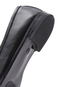 Black low heel shoe made of textured leather, featuring a rounded toe and a smooth rubber sole with a subtle tread pattern.