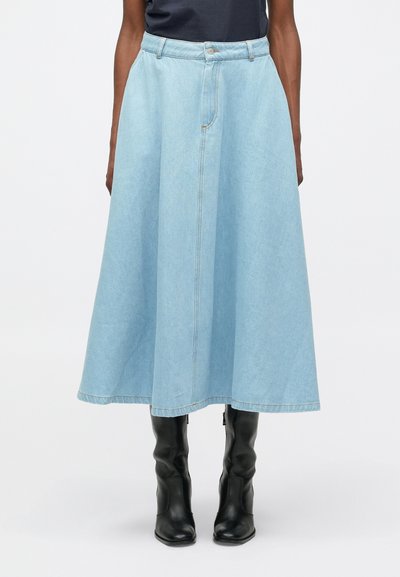 Lichtblauwe denim rok met een uitlopende vorm, lange lengte en voorzakken. Voorzien van een rits en zichtbare stikdetails.