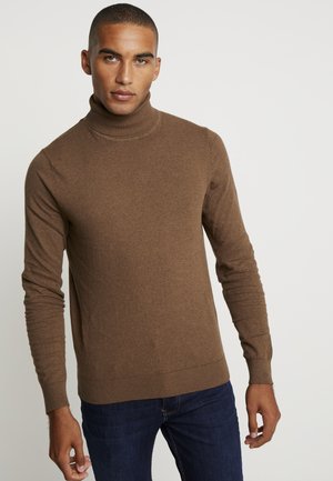 Brown turtleneck sweater made of a soft material, featuring long sleeves and ribbed cuffs and hem. Worn with blue jeans.