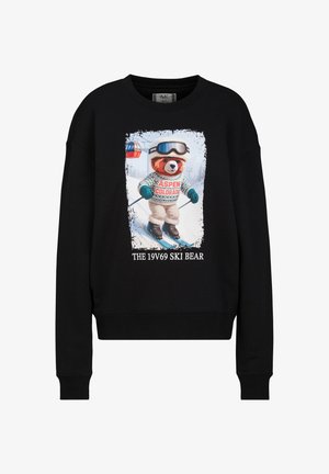 Zwarte trui met afbeelding van een beer die skiet, met een Aspen Colorado trui en skibril, tekst luidt "The 19V69 Ski Bear."