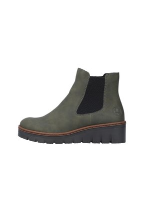 Olive green ankle boot with a smooth texture and elastic side panels, featuring a thick black rubber sole and brown stitching accents.