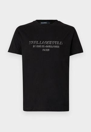 T-shirt en coton noir avec texte en relief blanc : "KARL LAGERFELD 21 RUE ST-GUILLAUME PARIS." Design à manches courtes et col rond.