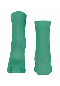 Grüne Socken mit Muster, die ein geometrisches Design und verstärkte Zehen- und Fersenbereiche aufweisen, aus einer atmungsaktiven Stoffmischung gefertigt.