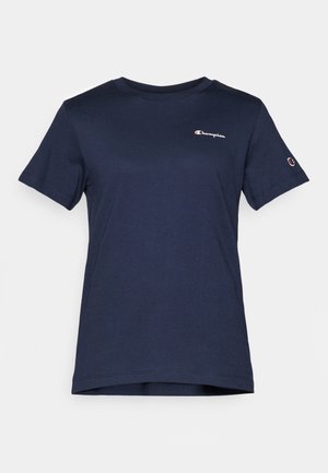 T-shirt in cotone blu navy con maniche corte, scollo tondo e un piccolo logo Champion sul petto. Orlo dritto nella parte inferiore.