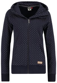 Hoodie zippé navy avec des pois roses, poches avant et capuche réglable. Tissu doux avec des poignets et un ourlet côtelés. Présence d'une étiquette de marque.
