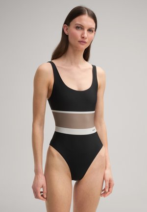 Zwarte badpak met een aansluitend ontwerp, voorzien van een transparante beige inzet en een witte accentband op de taille. Gladde textuur.