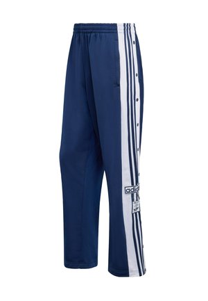 Tmavomodré teplákové nohavice s bielymi bočnými pruhmi, cvokmi a nášivkou s logom Adidas. Vyrobené z ľahkej tkaniny s hladkou textúrou.