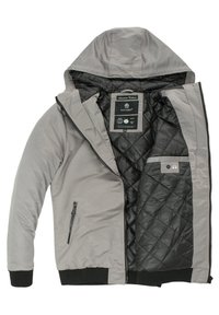 Gray hooded jacket with a quilted black lining, front zipper, side pockets, and ribbed cuffs. Label inside indicates brand and care instructions.