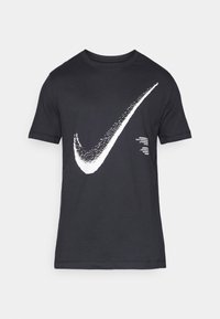 Μαύρο βαμβακερό t-shirt με μεγάλο λευκό λογότυπο Nike Swoosh στο εμπρός μέρος και επιπλέον κείμενο κοντά στο τελείωμα. Κοντά μανίκια και στρογγυλή λαιμόκοψη.